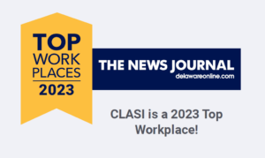 Yellow Banner with Blue Text Reads "Top Workplaces 2023" with a Blue Banner with White Text next to it reading "The News Journal delawareonline.com" and at the bottom in gray text are the words "CLASI is a 2023 Top Workplace!"