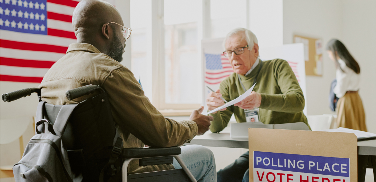 Man in wheelchair voting at a polling place